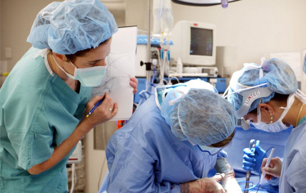 Director Sandone observing and illustrating surgery