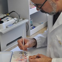 Juan Garcia provides some finishing touches to a prosthetic ear in his workshop here on the Johns Hopkins School of Medicine campus.